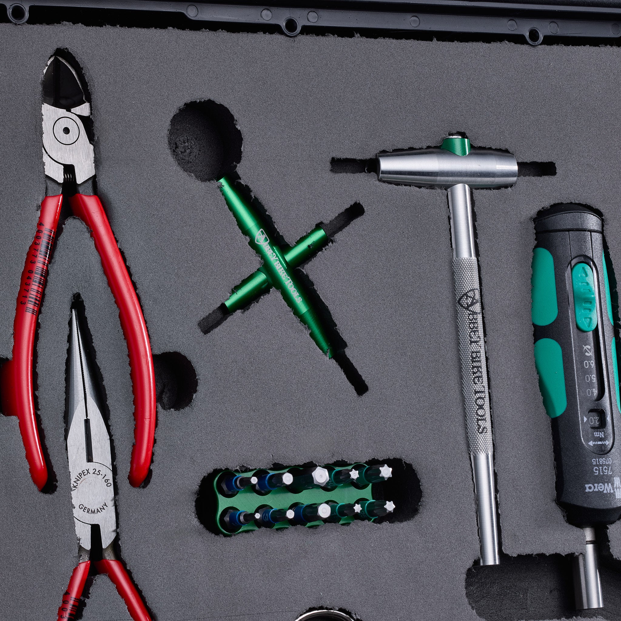 Set of tools including pliers and screwdrivers in foam